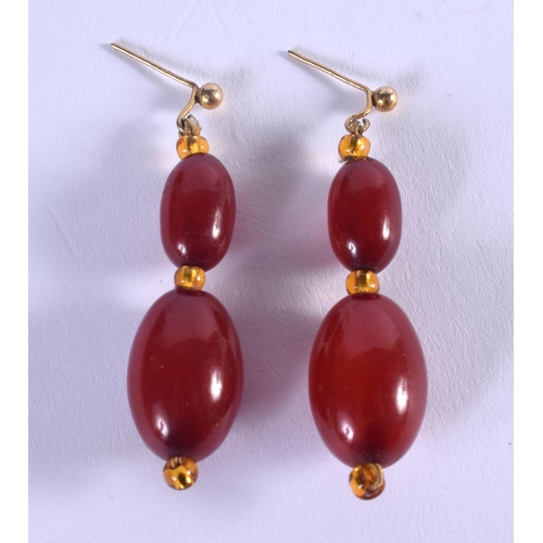 1176 - A PAIR OF ART DECO CHERRY AMBER BAKELITE EARRINGS. 5 grams. 4 cm long.