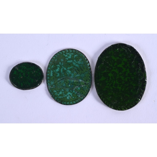 1184 - THREE 18TH/19TH CENTURY INDIAN GOLD INLAID GLASS PENDANTS. Largest 4.5 cm x 3 cm. (3)