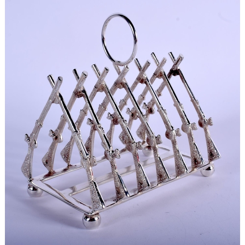 1225 - A SILVER PLATED RIFLE TOAST RACK. 11 cm x 5 cm.