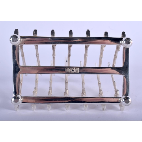 1225 - A SILVER PLATED RIFLE TOAST RACK. 11 cm x 5 cm.