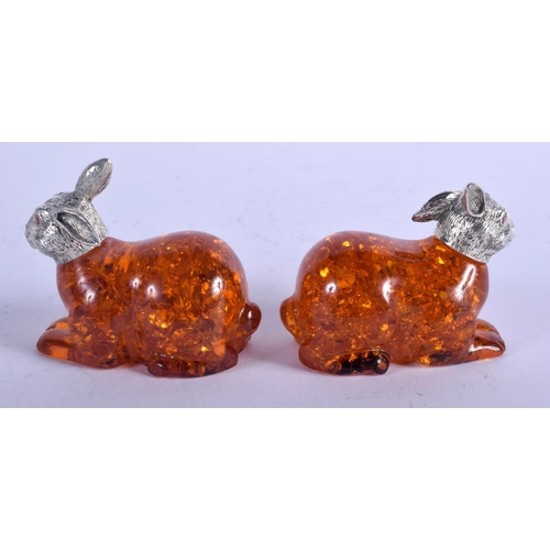 1277 - A PAIR OF SILVER AND AMBER HARES. 6 cm x 4 cm.