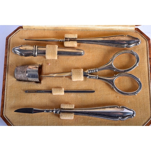 1283 - A BOXED SILVER MANICURE SET. 40 grams. Largest 11 cm long.