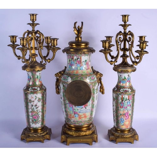 1492 - A RARE 19TH CENTURY CHINESE CANTON FAMILLE ROSE CLOCK GARNITURE Qing, painted with figures in variou... 