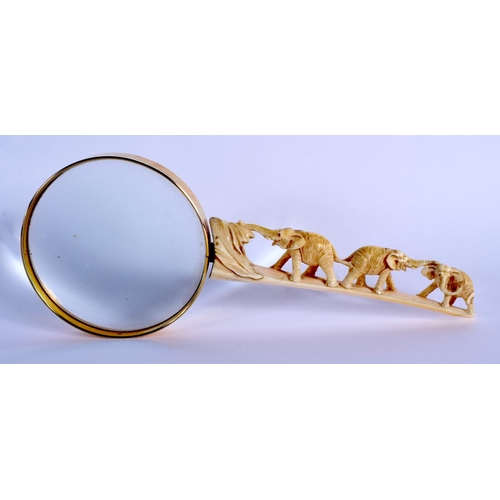 1506 - A 19TH CENTURY JAPANESE MEIJI PERIOD CARVED IVORY MAGNIFYING GLASS with elephant handle. 25 cm wide.