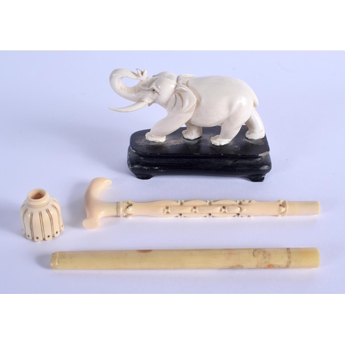 1510 - A 19TH CENTURY JAPANESE MEIJI PERIOD CARVED IVORY OKIMONO OF AN ELEPHANT together with three others.... 