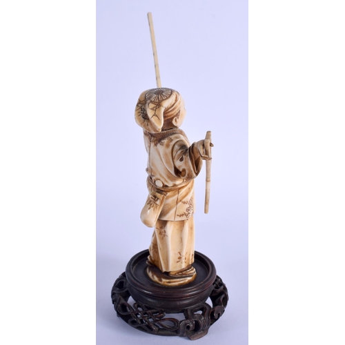 1513 - A 19TH CENTURY JAPANESE MEIJI PERIOD CARVED IVORY OKIMONO modelled holding a long stick. Ivory 16.5 ... 