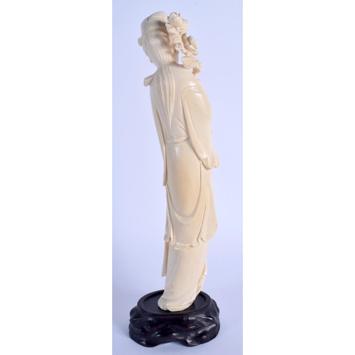 1535 - A LARGE LATE 19TH CENTURY CHINESE CARVED IVORY FIGURE OF AN IMMORTAL Qing, modelled holding a floral... 