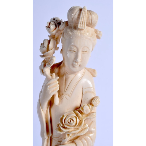 1535 - A LARGE LATE 19TH CENTURY CHINESE CARVED IVORY FIGURE OF AN IMMORTAL Qing, modelled holding a floral... 