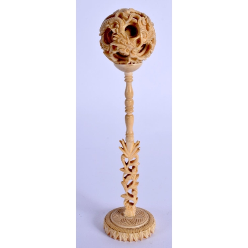 1549 - A 19TH CENTURY CHINESE CARVED CANTON IVORY PUZZLE BALL ON STAND. 15 cm x 3 cm.