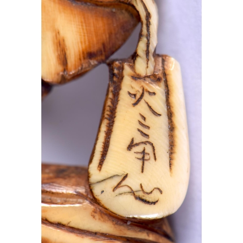 1558 - A 19TH CENTURY JAPANESE MEIJI PERIOD CARVED IVORY NETSUKE modelled as a male leaning upon a sack. 4.... 