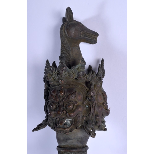 1570 - A LARGE CHINESE TIBETAN BRONZE PHURBA modelled with buddhistic mask heads. 60 cm long.