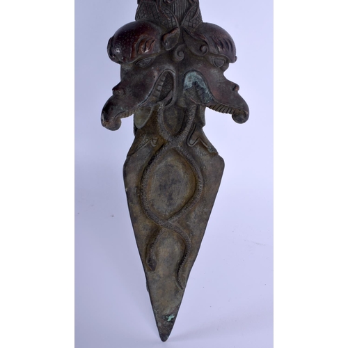 1570 - A LARGE CHINESE TIBETAN BRONZE PHURBA modelled with buddhistic mask heads. 60 cm long.