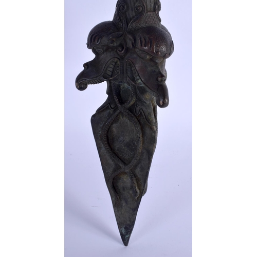 1570 - A LARGE CHINESE TIBETAN BRONZE PHURBA modelled with buddhistic mask heads. 60 cm long.