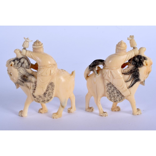 1576 - A PAIR OF 19TH CENTURY CHINESE CARVED CANTON IVORY LIONS modelled with attendants. 8.5 cm x 6.5 cm.