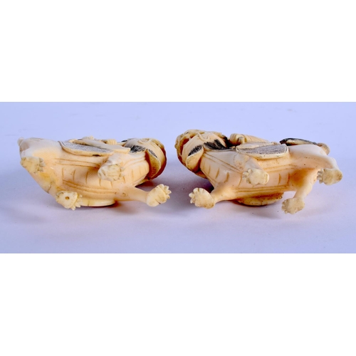 1576 - A PAIR OF 19TH CENTURY CHINESE CARVED CANTON IVORY LIONS modelled with attendants. 8.5 cm x 6.5 cm.