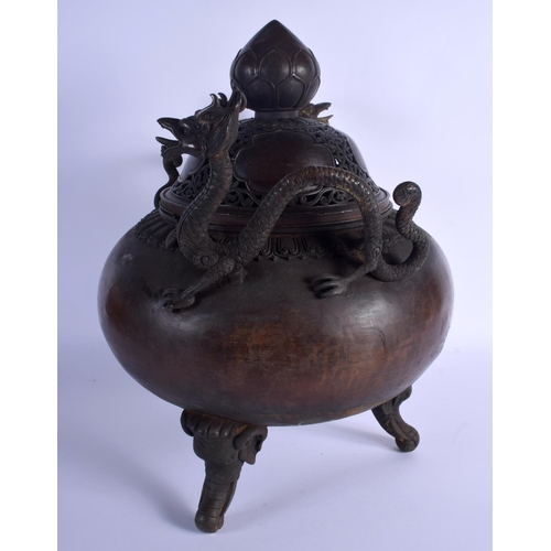 1582 - A LARGE CHINESE TWIN HANDLED BRONZE CENSER AND COVER 20th Century, decorated with foliage and vines.... 