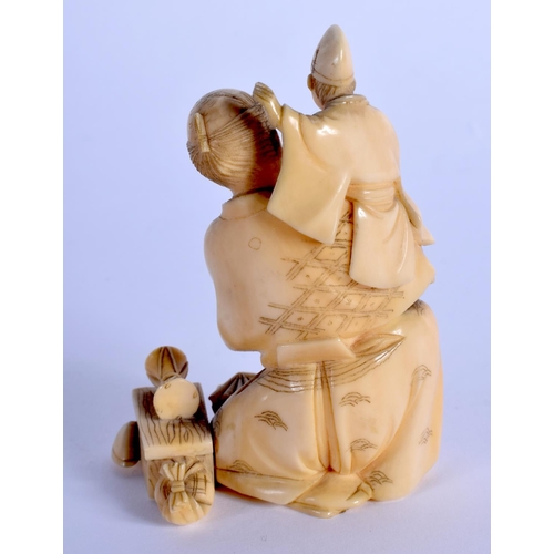 1590 - A 19TH CENTURY JAPANESE MEIJI PERIOD CARVED IVORY OKIMONO modelled as a male and a child. 8 cm x 5 c... 