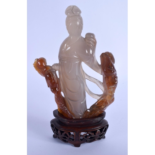 1640 - AN EARLY 20TH CENTURY CHINESE CARVED AGATE FIGURE OF A FEMALE Late Qing, modelled beside a peering c... 