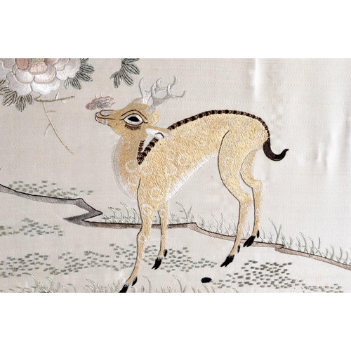 1644 - A 19TH CENTURY CHINESE SILKWORK EMBROIDERED PANEL Qing, depicting two deer roaming within a landscap... 