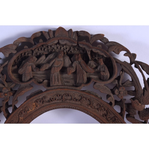 1651 - A 19TH CENTURY CHINESE CARVED CANTON SANDALWOOD SWINGING FRAME Qing, decorated with figures and foli... 