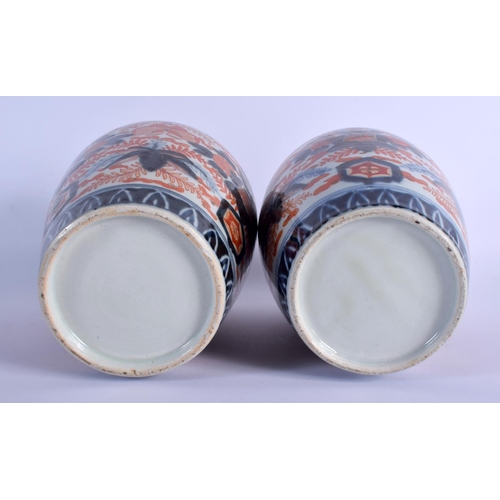 1711 - A PAIR OF 19TH CENTURY JAPANESE MEIJI PERIOD IMARI PORCELAIN VASES painted with foliage and insects.... 