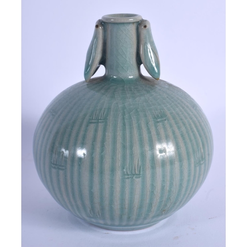 1714 - A KOREAN CELADON TWIN HANDLED BULBOUS VASE. 14 cm x 9 cm.