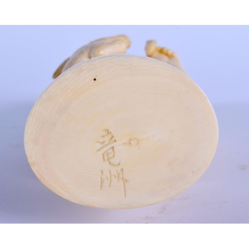 1715 - A 19TH CENTURY JAPANESE MEIJI PERIOD CARVED IVORY OKIMONO modelled as a male holding aloft a rabbit.... 