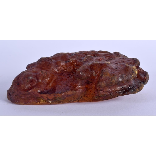 1723 - A RARE EARLY 20TH CENTURY CHINESE CARVED AMBER SCHOLARS BOULDER Late Qing. 497 grams. 14 cm x 10 cm.