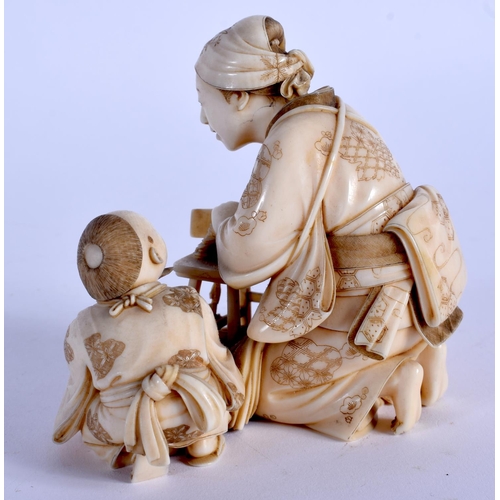 1725 - A FINE 19TH CENTURY JAPANESE MEIJI PERIOD CARVED IVORY OKIMONO modelled as a female and child prepar... 