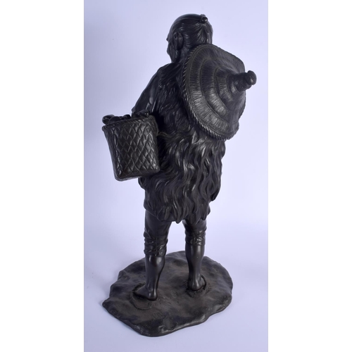 1735 - A LARGE 19TH CENTURY JAPANESE MEIJI PERIOD BRONZE OKIMONO modelled as a standing farmer holding a pi... 