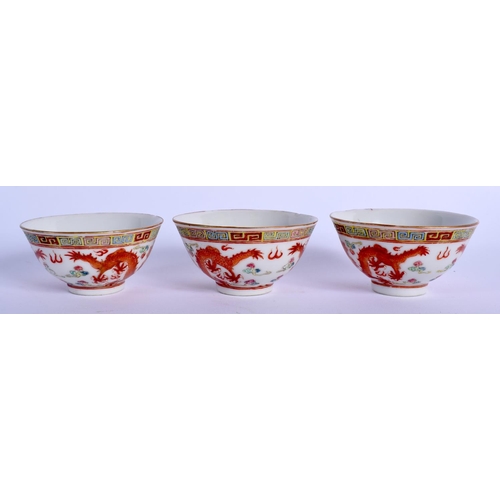 1749 - A SET OF THREE EARLY 20TH CENTURY CHINESE FAMILLE ROSE DRAGON TEABOWLS Guangxu mark and period, pain... 