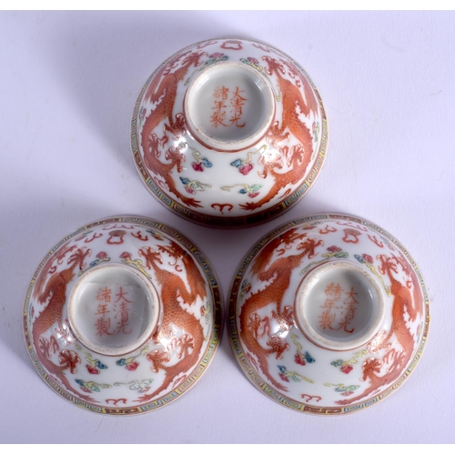 1749 - A SET OF THREE EARLY 20TH CENTURY CHINESE FAMILLE ROSE DRAGON TEABOWLS Guangxu mark and period, pain... 