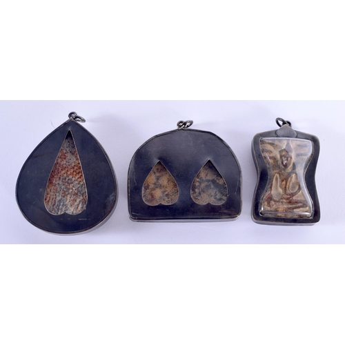 1764 - THREE EARLY 20TH CENTURY TIBETAN SILVER AND POTTERY ICONS. 5.5 cm x 3.5 cm.