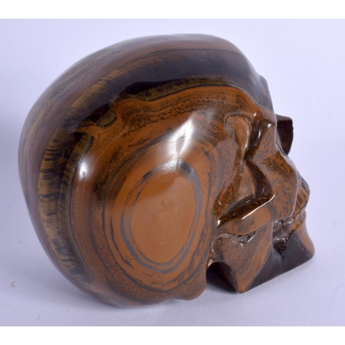 1776 - A CHINESE CARVED TIGERS EYE MODEL OF A SKULL 20th Century. 8.5 cm x 7 cm.