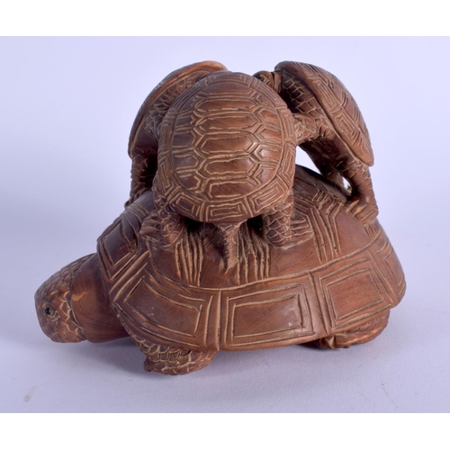 1789 - A JAPANESE CARVED WOOD FIGURE OF A TORTOISE modelled with three tortoise upon its back. 10 cm x 8 cm... 