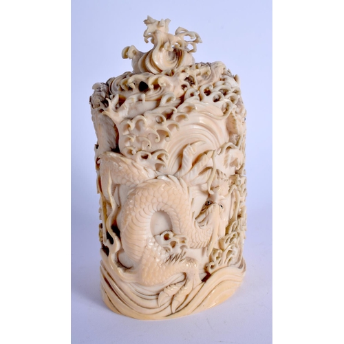 1792 - A 19TH CENTURY JAPANESE MEIJI PERIOD CARVED IVORY DRAGON VASE AND COVER modelled amongst crashing wa... 