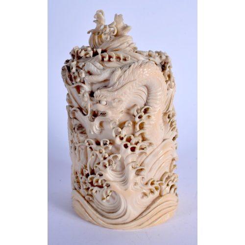 1792 - A 19TH CENTURY JAPANESE MEIJI PERIOD CARVED IVORY DRAGON VASE AND COVER modelled amongst crashing wa... 