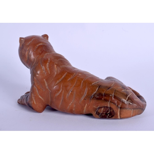 1797 - A JAPANESE BOXWOOD FIGURE OF A RECLINING TIGER. 14 cm x 8 cm.