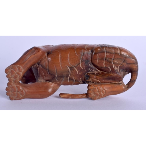 1797 - A JAPANESE BOXWOOD FIGURE OF A RECLINING TIGER. 14 cm x 8 cm.