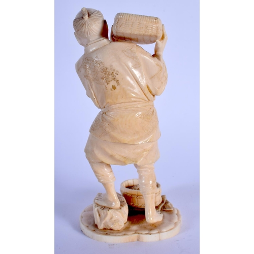 1822 - A 19TH CENTURY JAPANESE MEIJI PERIOD CARVED IVORY OKIMONO modelled as a male pouring grain. 14.5 cm ... 