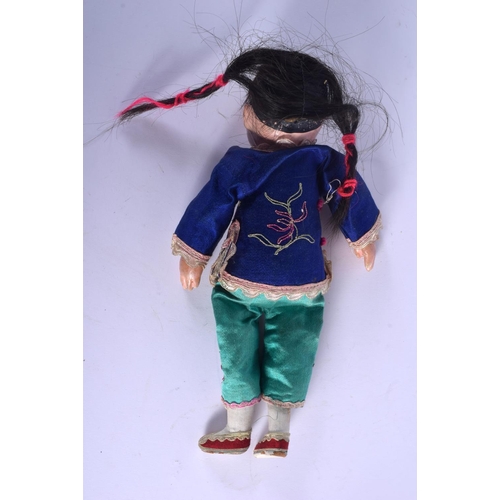 1828 - AN EARLY 20TH CENTURY CHINESE FIGURE OF A DOLL Late Qing, modelled wearing a silk robe. 23 cm long.