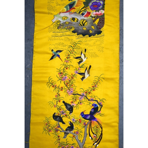 1849 - A LONG 19TH CENTURY CHINESE YELLOW SILK EMBROIDERED PANEL Qing, decorated with hundreds of birds wit... 