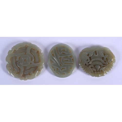 1858 - THREE CHINESE CARVED JADE PLAQUE PENDANTS 20th Century, in various forms and sizes. Largest 5 cm x 5... 