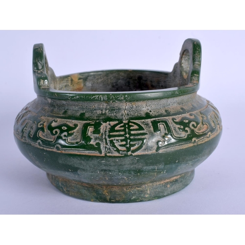 1886 - A CHINESE TWIN HANDLED JADE CENSER 20th Century, decorated with archaic motifs. 13.5 cm wide.