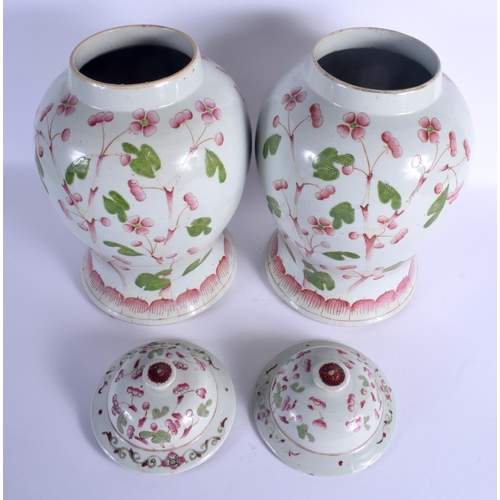 1921 - A VERY RARE PAIR OF MID 19TH CENTURY CHINESE FAMILLE ROSE VASES AND COVERS Qing, unusually painted w... 