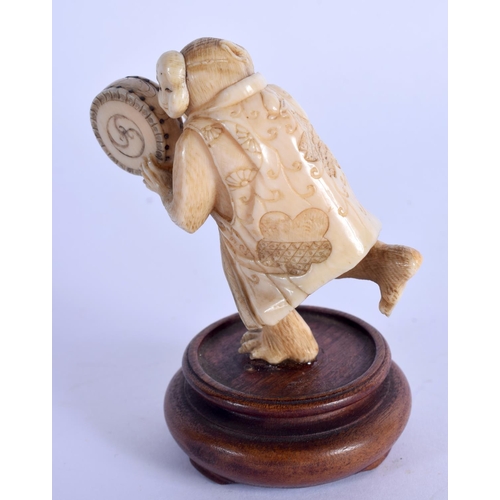 1928 - A 19TH CENTURY JAPANESE MEIJI PERIOD CARVED IVORY OKIMONO modelled beating a drum. Ivory 6 cm x 4 cm... 