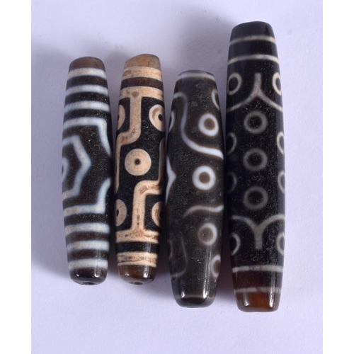 1947 - FOUR CHINESE TIBETAN CARVED AGATE ZHU BEADS 20th Century. Largest 6.75 cm wide. (4)