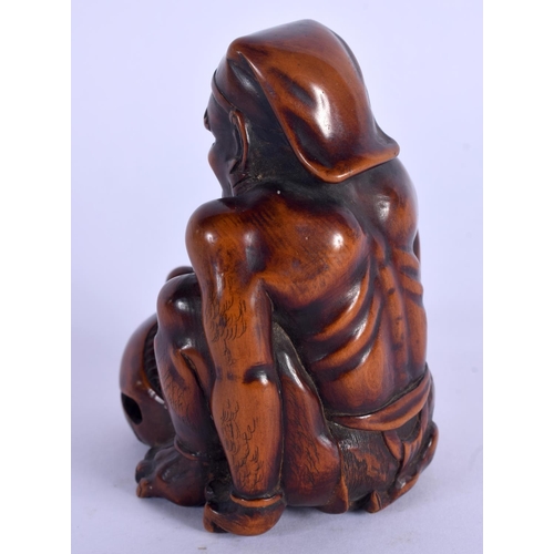 1978 - A 19TH CENTURY CARVED  NUT OKIMONO modelled as a muscular. 9.5 cm x 5.5 cm.