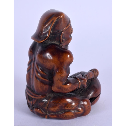 1978 - A 19TH CENTURY CARVED  NUT OKIMONO modelled as a muscular. 9.5 cm x 5.5 cm.