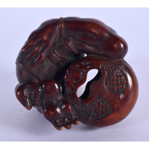 1978 - A 19TH CENTURY CARVED  NUT OKIMONO modelled as a muscular. 9.5 cm x 5.5 cm.